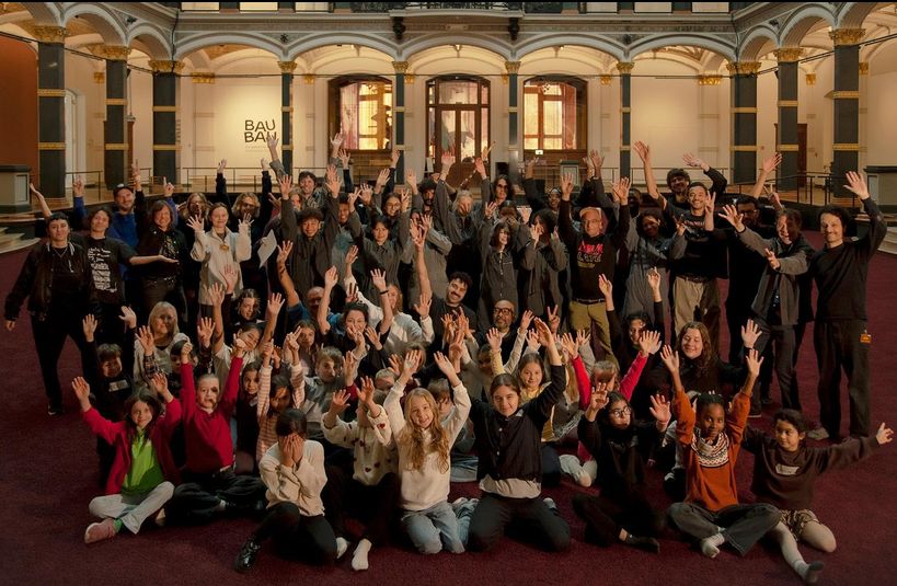 Dream Baby Dream — full cast group photo, arms raised, inside the Bauhaus-Archiv atrium