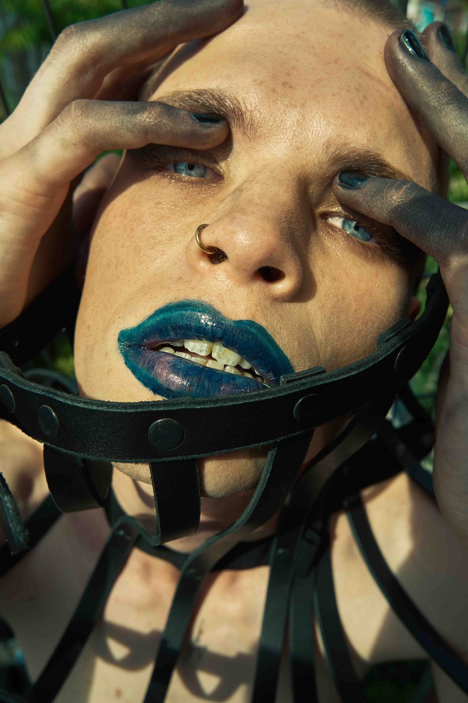 Berlin Freiheit — blue-lipped close-up in a leather harness