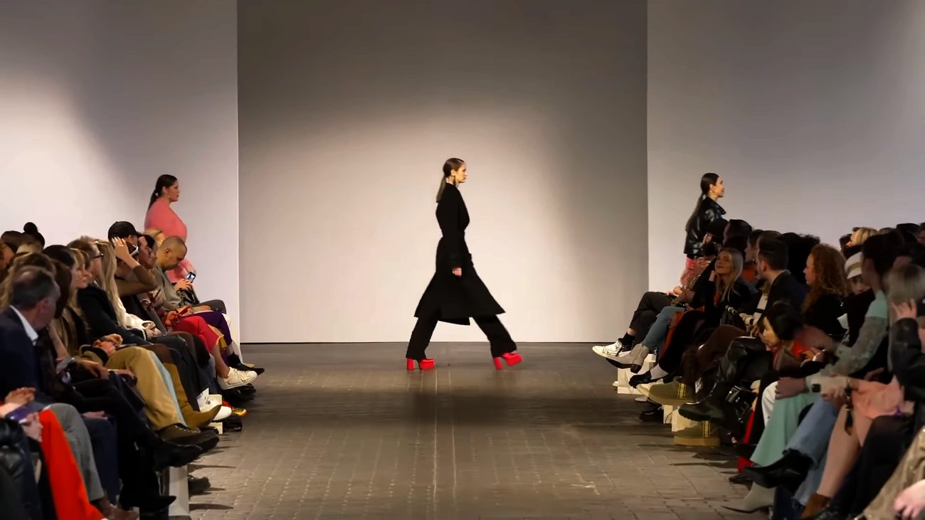 WE.4 runway — model in a green and white blazer
