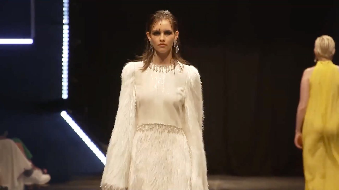 WE.4 runway — model in a white fringed dress